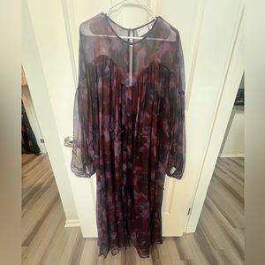 Multi-colored watercolor full-length dress with waist tie and billowy sleeves.